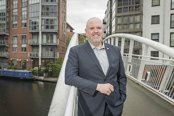 Lee standing on a bridge, over a Ladywood canal