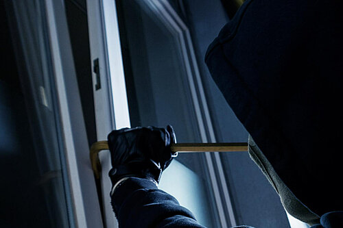 Burglar attempting to pry open a window